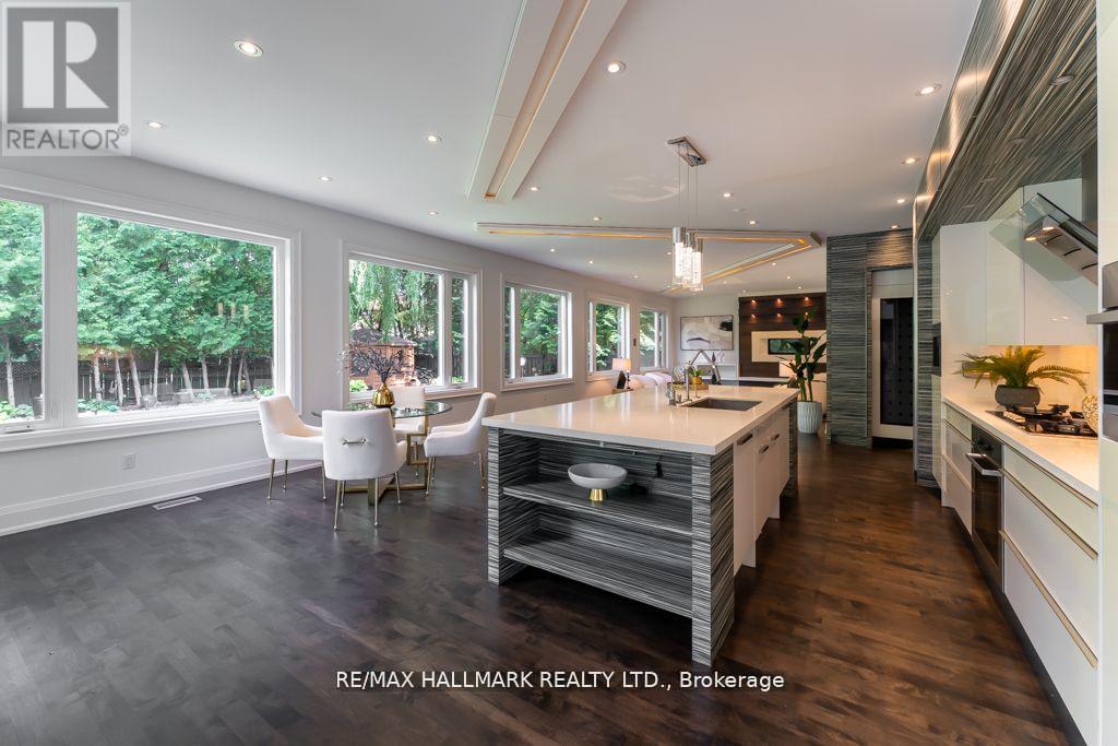 A modern kitchen with a dining table and chairs is showcased.