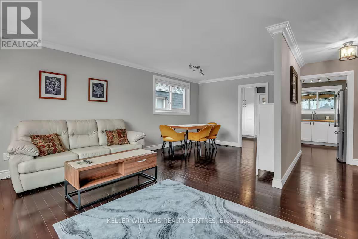 A living room with a white couch and a wooden coffee table.