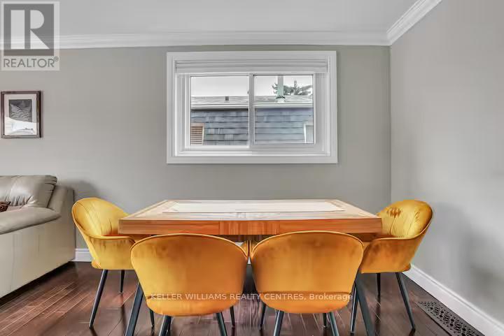 A dining room with a table and chairs.