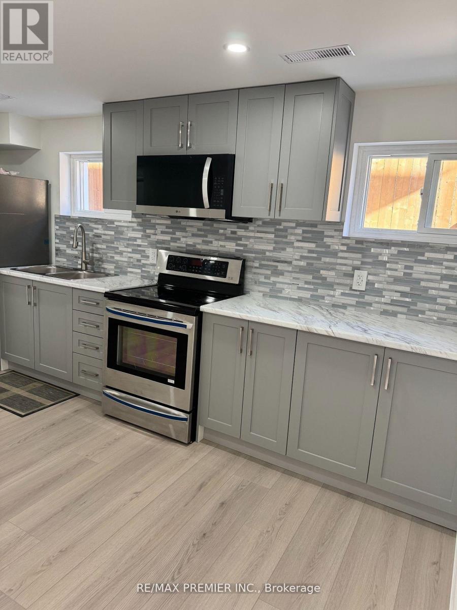 A kitchen with a stove top oven and a microwave.