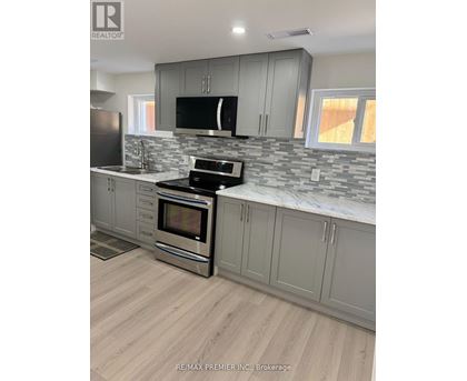 A kitchen with a stove top oven and a microwave.
