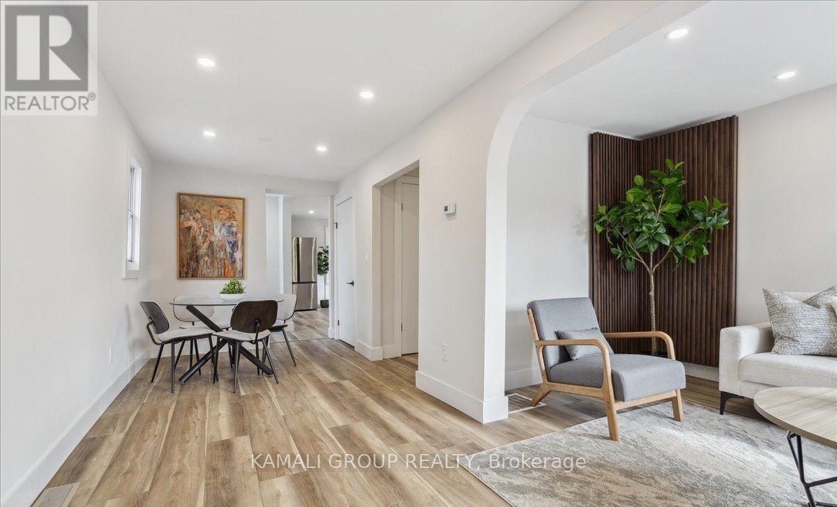 A living room with a dining table and chairs.