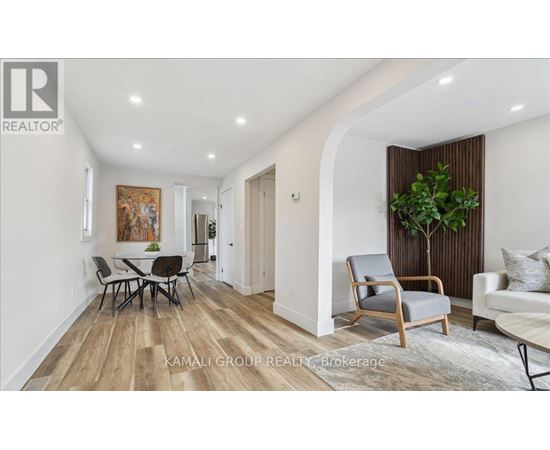 A living room with a dining table and chairs.