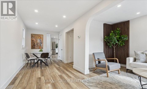 A living room with a dining table and chairs.
