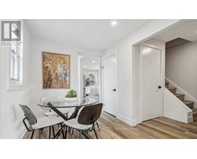 A dining room with a glass table and chairs.