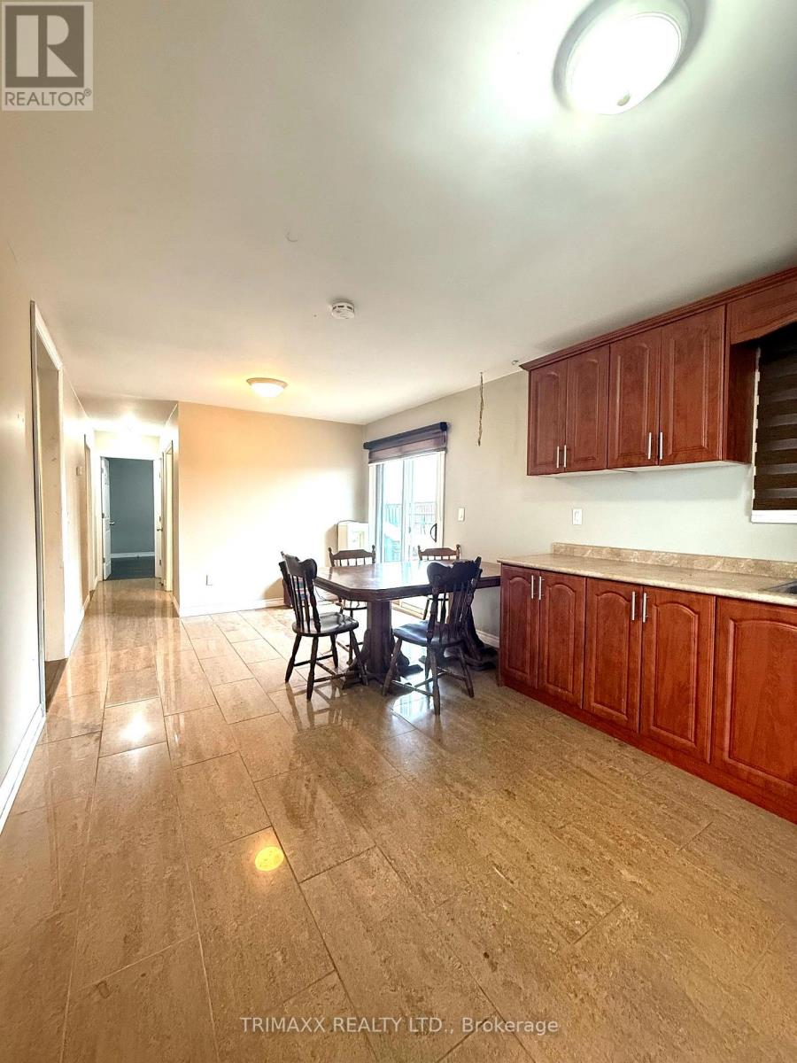 A kitchen with wooden cabinets and a dining table.