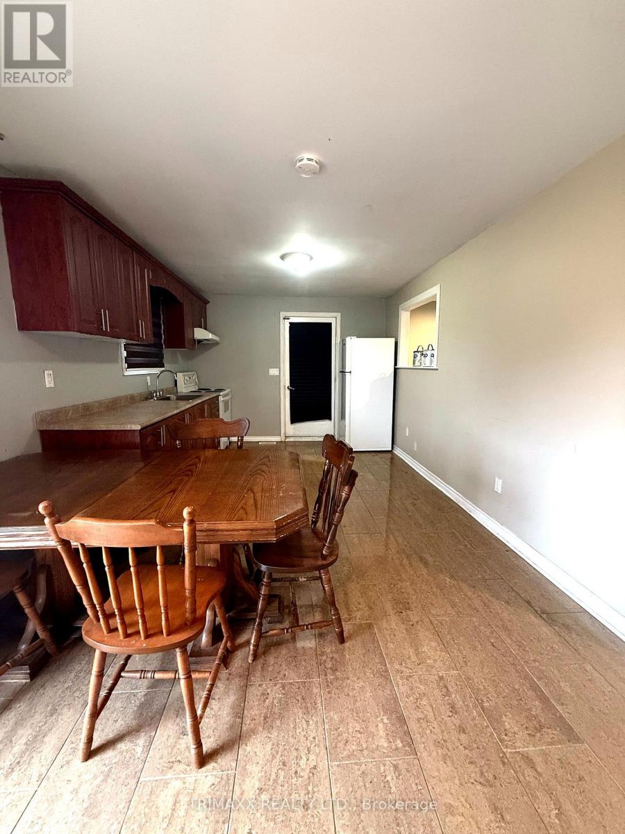 A wooden dining table with chairs in a room.