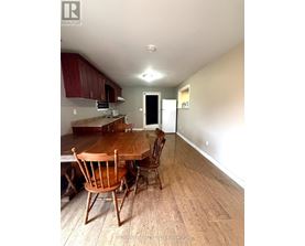 A wooden dining table with chairs in a room.