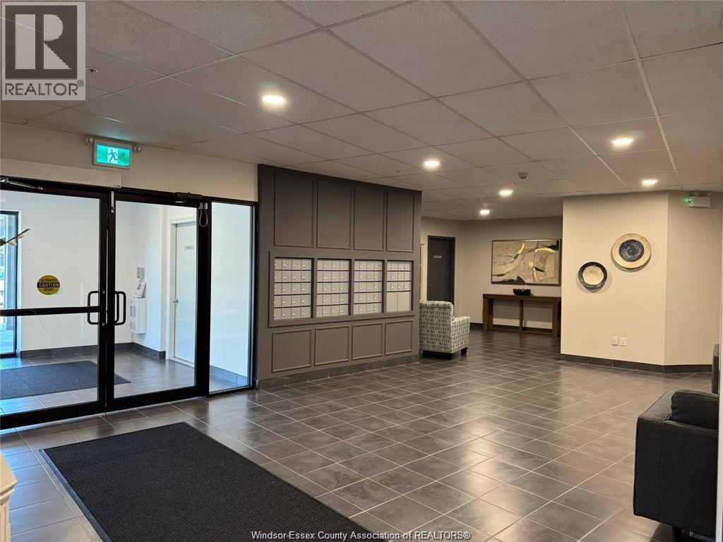 A hallway with a black door and a sign that says REALTOR.