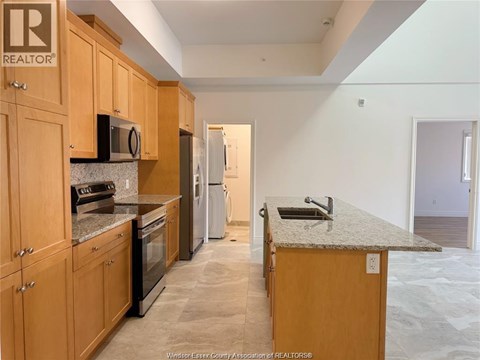 A kitchen with wooden cabinets and granite countertops.