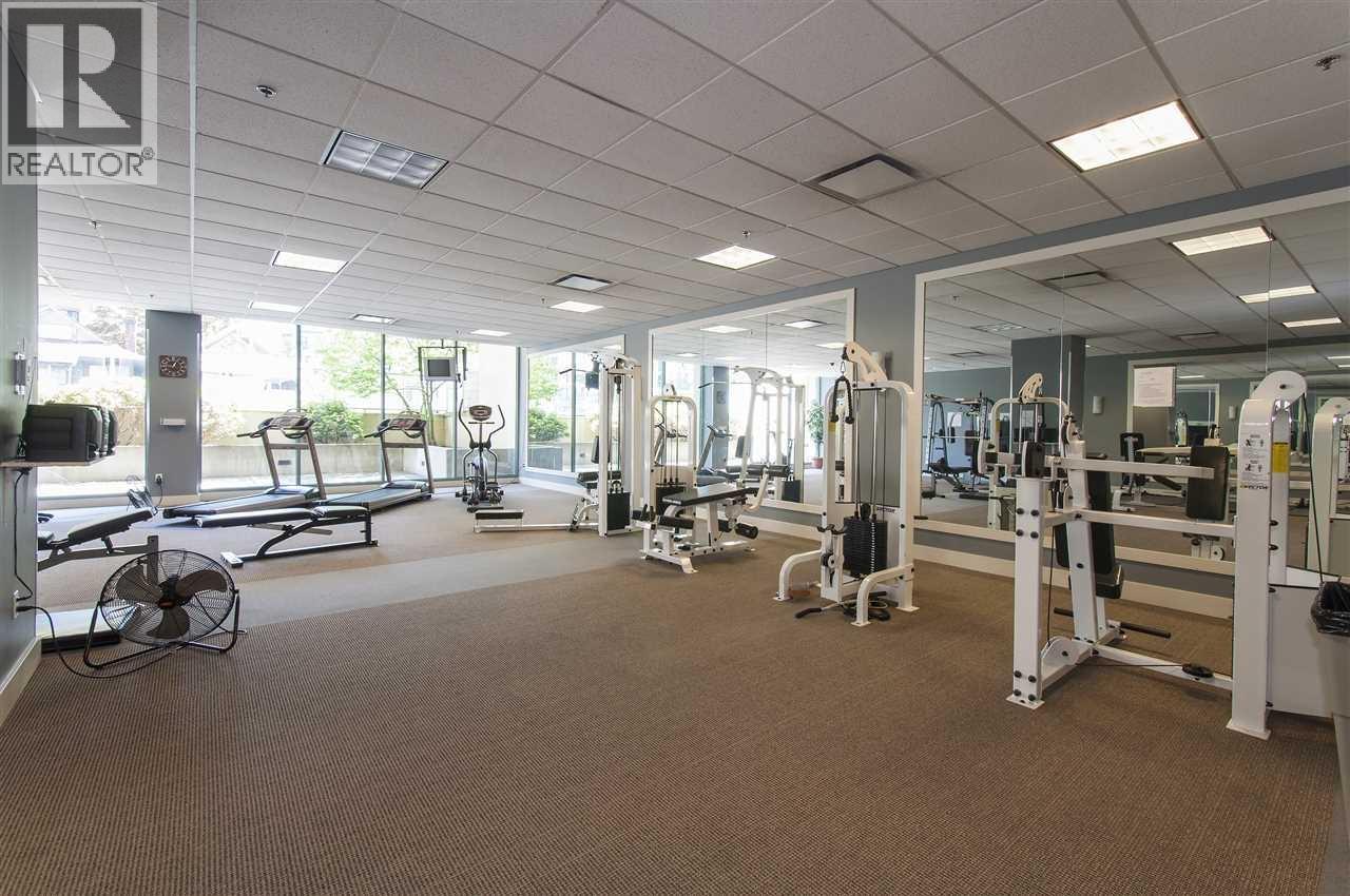 A gym with a variety of equipment including treadmills, weights, and exercise machines.