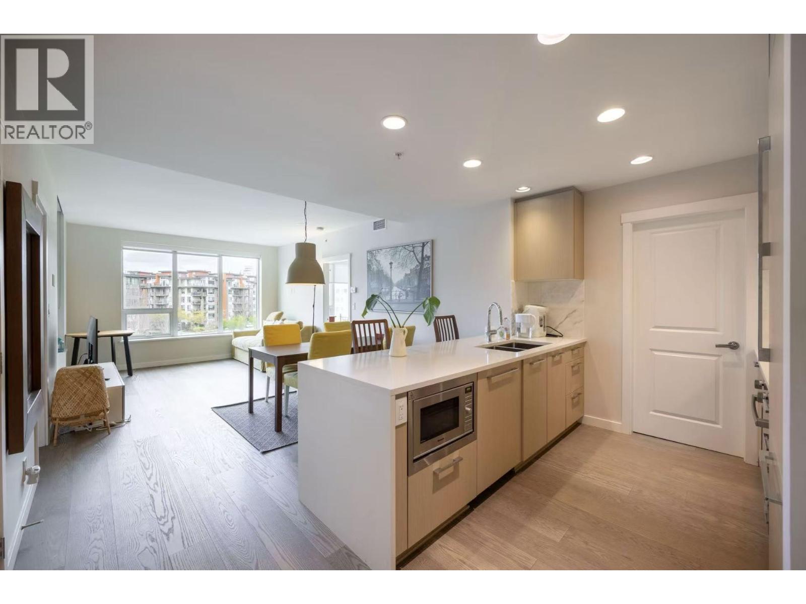 A modern kitchen with wooden cabinets and a white island.