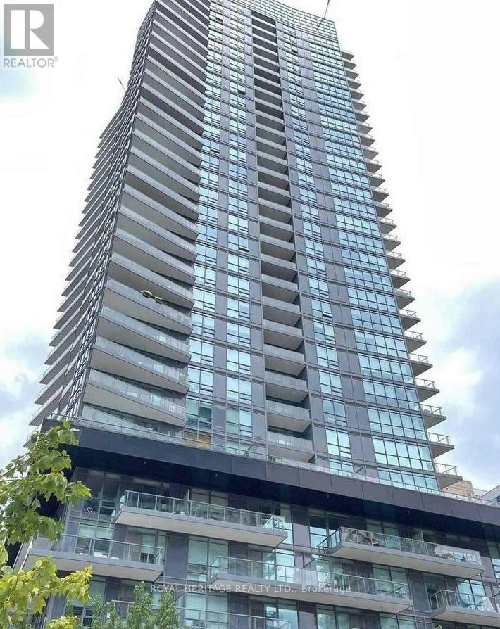 A tall building with many windows and balconies is shown.