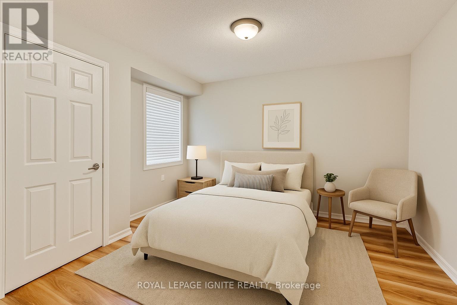 A bedroom with a bed, chair, and lamp.