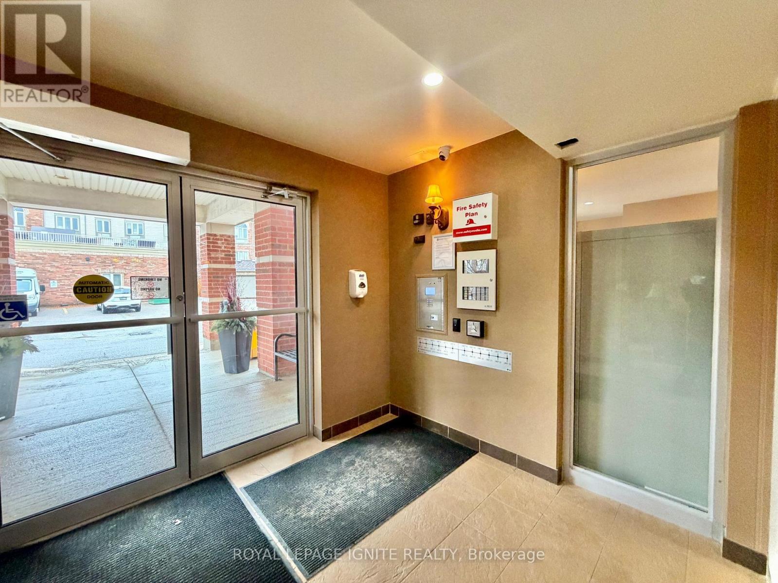 A hallway with a glass door leading to a balcony.