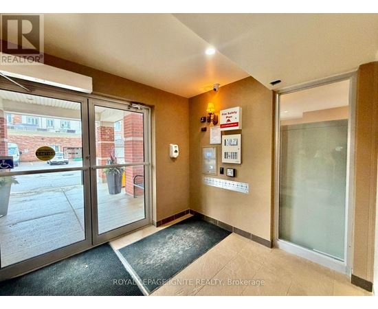 A hallway with a glass door leading to a balcony.