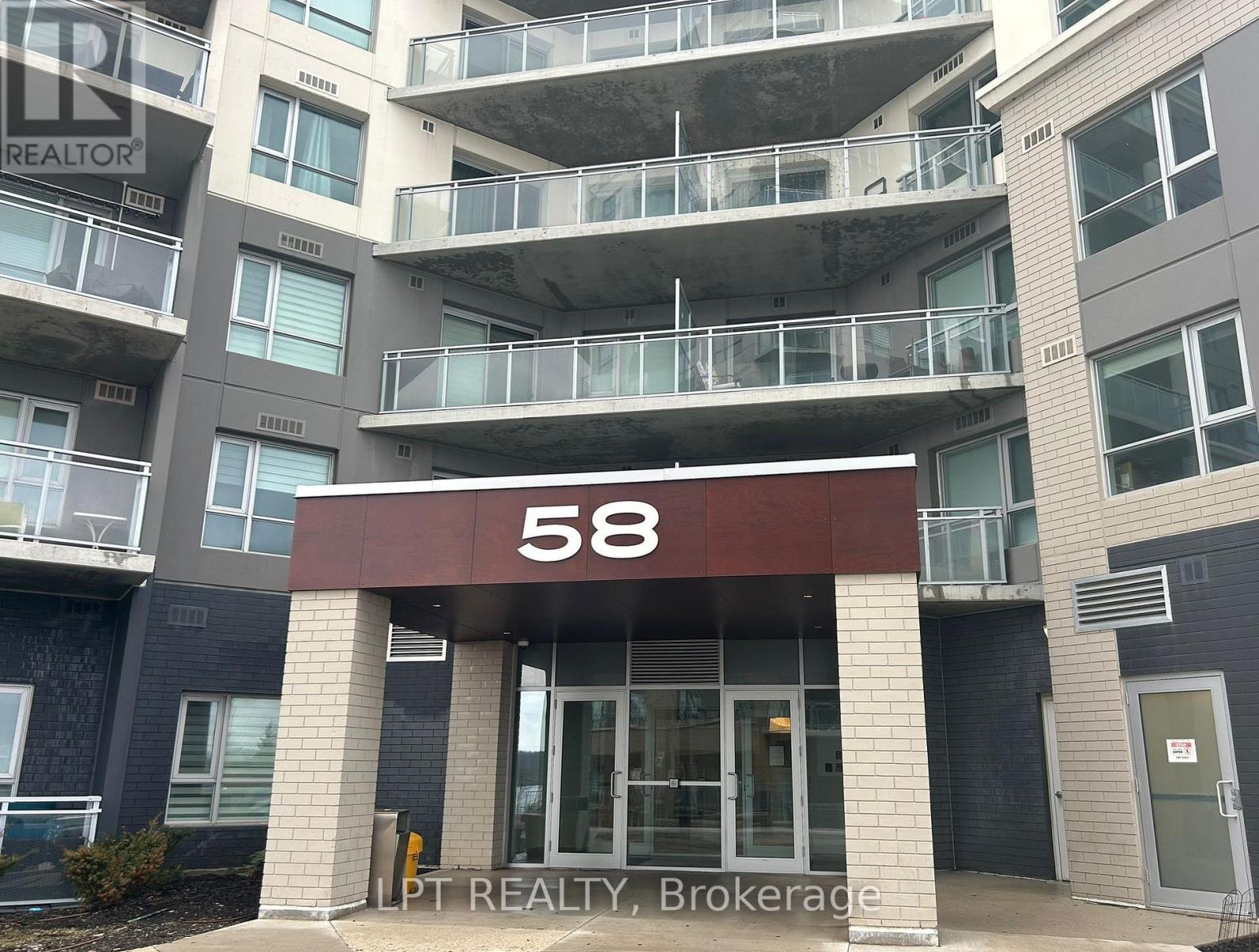 The entrance to apartment building number 58 with a sign for LPT Realty, Brokerage.