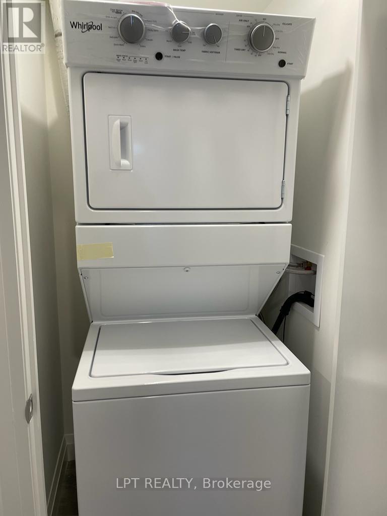 A white Whirlpool washing machine with the door open.