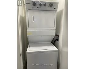A white Whirlpool washing machine with the door open.