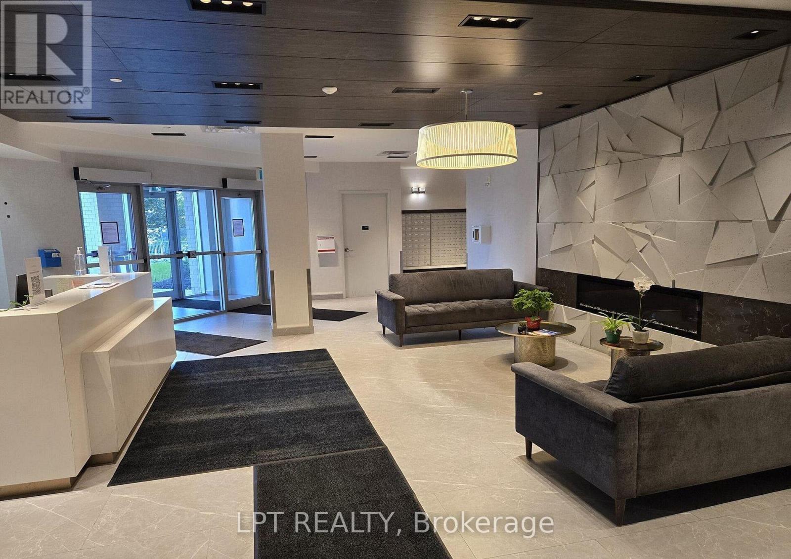 A realtor brokerage office with a reception desk and a couch.