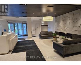 A realtor brokerage office with a reception desk and a couch.