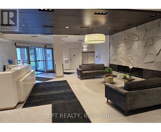 A realtor brokerage office with a reception desk and a couch.