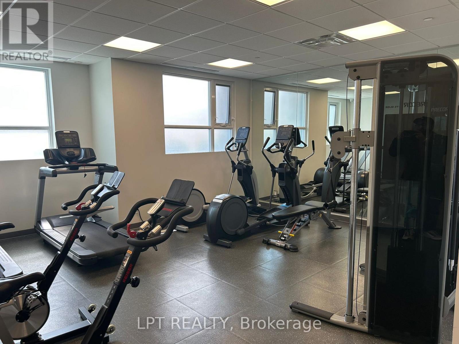A gym with treadmills, elliptical machines, and other exercise equipment.