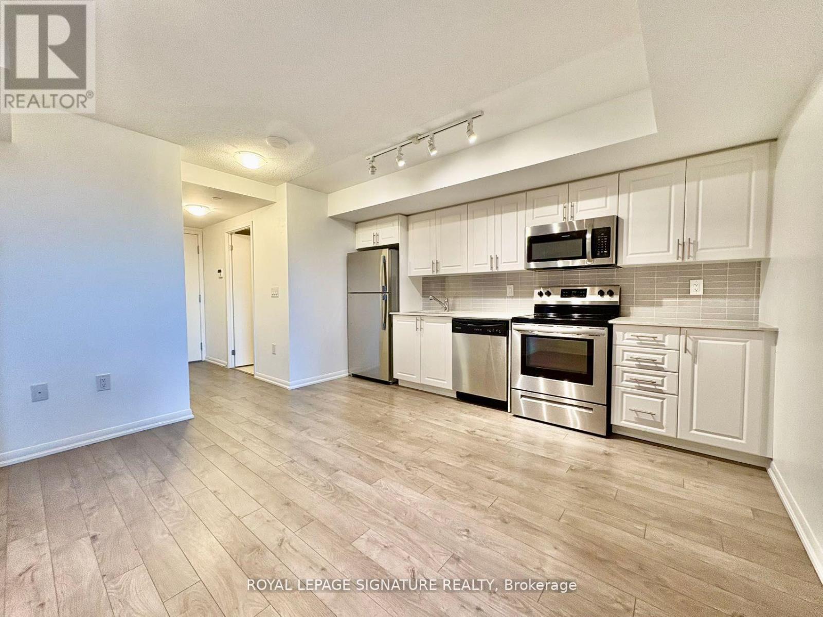 A kitchen with white cabinets and stainless steel appliances.