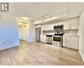 A kitchen with white cabinets and stainless steel appliances.