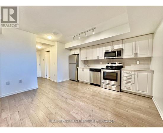 A kitchen with white cabinets and stainless steel appliances.