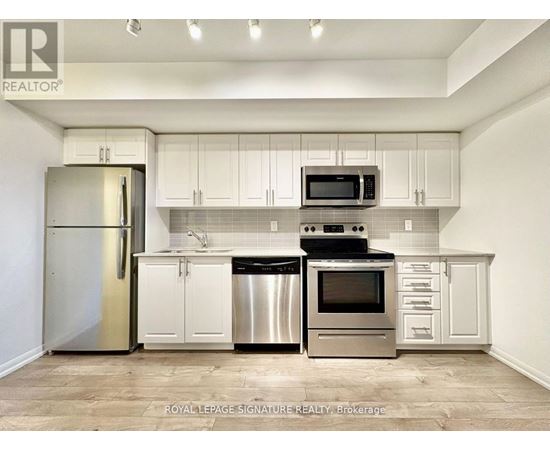 A kitchen with white cabinets and stainless steel appliances.