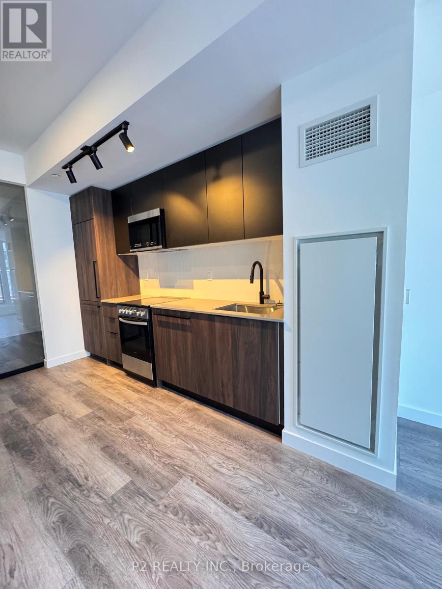 A modern kitchen with dark wood cabinets and a white countertop.