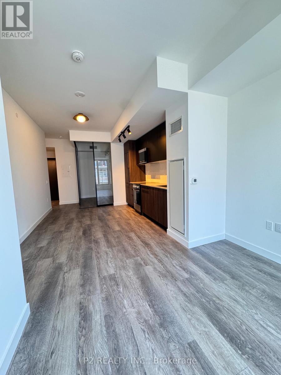 A spacious room with a grey floor and white walls.