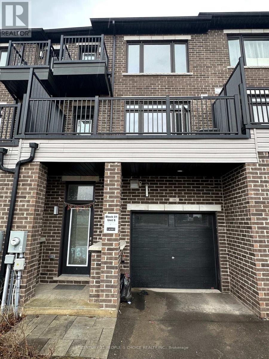 A building with a black garage door and a balcony.