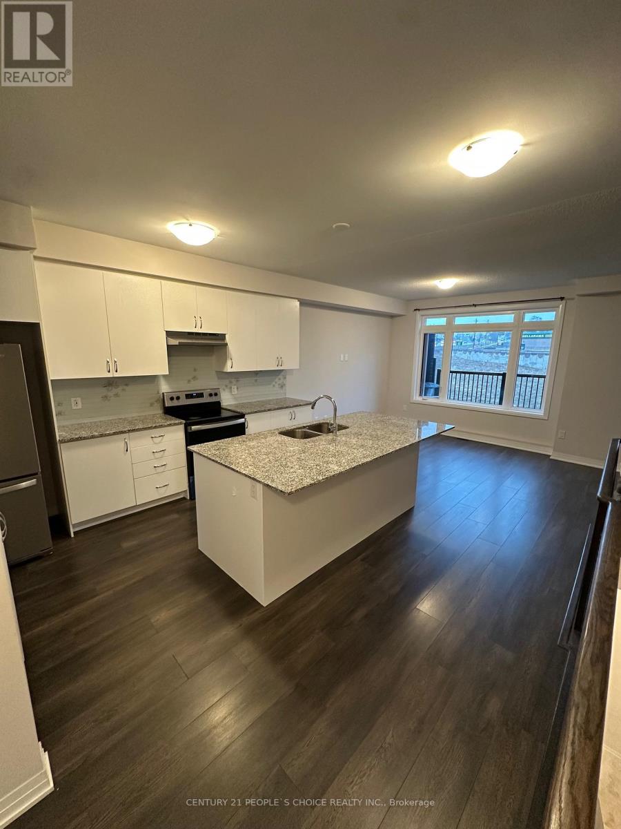 A kitchen with white cabinets and a granite countertop.