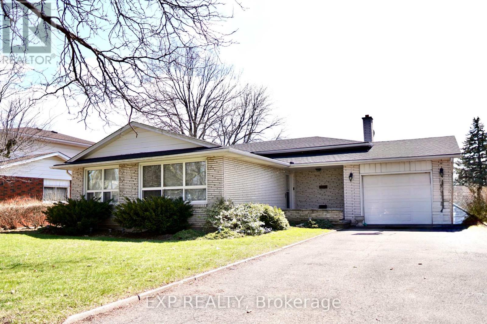 A house with a white garage door is for sale.