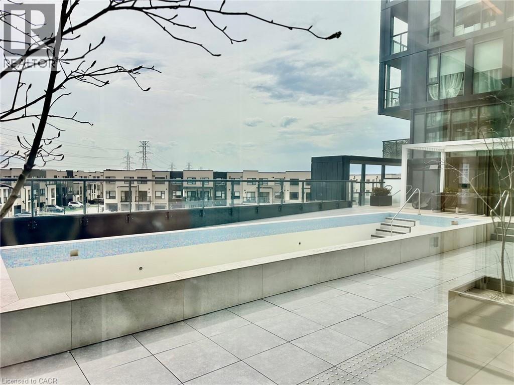 A pool area with a building in the background.