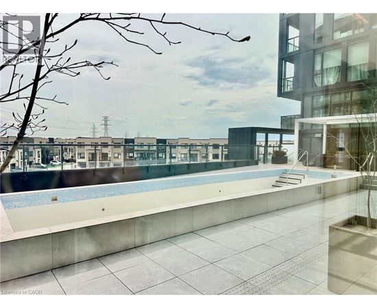 A pool area with a building in the background.