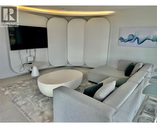 A modern living room with a grey sofa and a white coffee table.