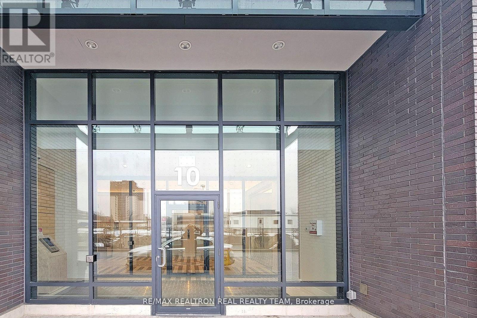 The image shows the entrance to a building with a glass door and a number 10 on it.