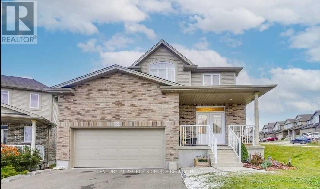 A house with a garage is for sale.