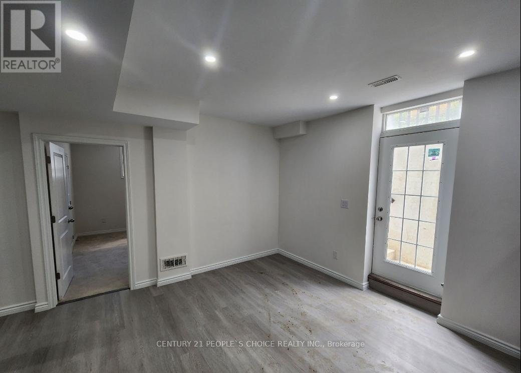 A room with a door and a window, with a logo on the wall.