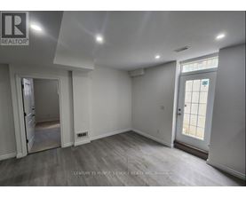 A room with a door and a window, with a logo on the wall.