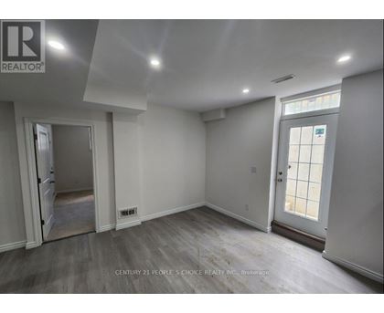 A room with a door and a window, with a logo on the wall.