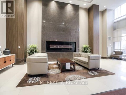 A modern living room with a fireplace and a rug on the floor.