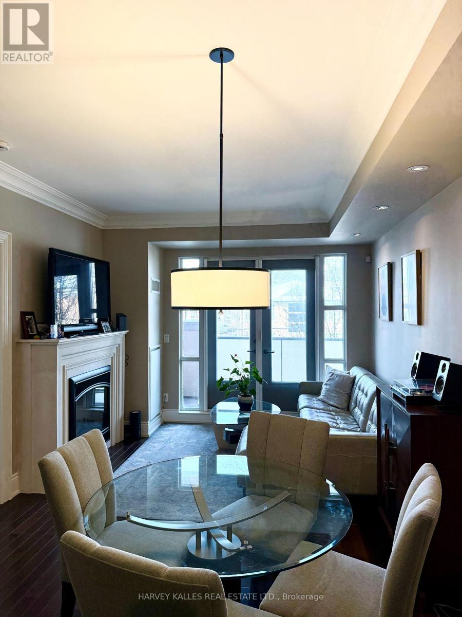 A modern dining room with a glass table and chairs.