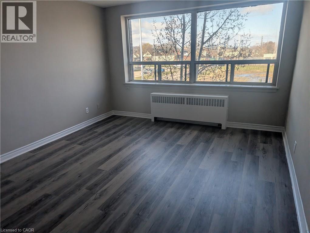A room with a window and a radiator on the floor.