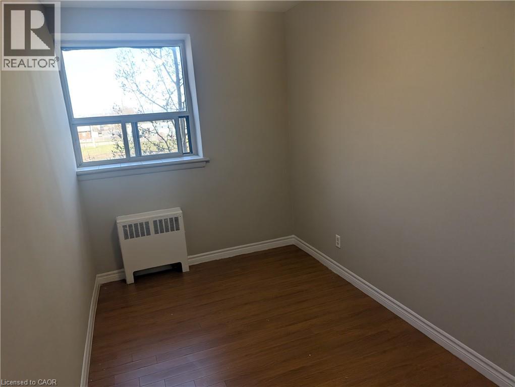 A room with a window and a heater.