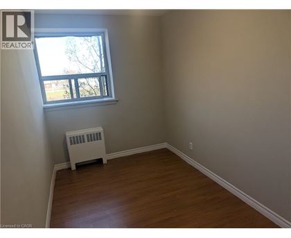 A room with a window and a heater.