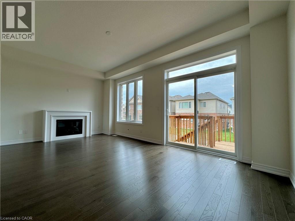 A spacious living room with a fireplace and sliding glass doors.